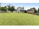Exterior shot of the back of a two-story home with a large grassy backyard and wooden fence at 3340 Deerwood Ln, Rex, GA 30273