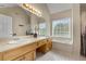 Bright bathroom featuring a double sink vanity, a soaking tub, and a large mirror at 3340 Deerwood Ln, Rex, GA 30273