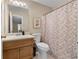Bathroom featuring a single sink vanity, a toilet, and a shower with a patterned curtain at 3340 Deerwood Ln, Rex, GA 30273
