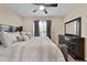 Bedroom featuring neutral walls, a ceiling fan, a window, and a black dresser at 3340 Deerwood Ln, Rex, GA 30273