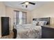 Bedroom featuring neutral walls, a ceiling fan, a window, and a black dresser at 3340 Deerwood Ln, Rex, GA 30273