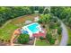 Community pool and pond surrounded by lush greenery, providing a relaxing recreational area at 3340 Deerwood Ln, Rex, GA 30273