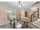 Dining room featuring a wooden table with seating for four near the wooden stairs at 3340 Deerwood Ln, Rex, GA 30273