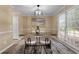 Dining room with modern light fixture, large window, and neutral walls at 3340 Deerwood Ln, Rex, GA 30273