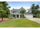 Charming two-story home featuring gray siding, black shutters and a well-manicured lawn at 3340 Deerwood Ln, Rex, GA 30273