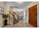 Inviting foyer with hardwood floors, staircase, and view of the dining room at 3340 Deerwood Ln, Rex, GA 30273