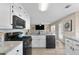 Well-lit kitchen with stainless steel appliances, granite countertops, and white cabinetry at 3340 Deerwood Ln, Rex, GA 30273