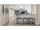 Open concept kitchen with breakfast bar, pendant lighting, white cabinetry and granite countertops at 3340 Deerwood Ln, Rex, GA 30273