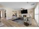 Bright living room featuring a fireplace, mounted TV, and neutral furniture at 3340 Deerwood Ln, Rex, GA 30273
