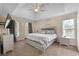 Inviting main bedroom features tray ceiling, large windows, and neutral decor at 3340 Deerwood Ln, Rex, GA 30273