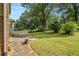 Well-maintained backyard with lush grass, featuring a patio and mature trees at 4819 Elam Rd, Stone Mountain, GA 30083