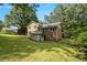 Spacious backyard with mature trees, showcasing the home's exterior at 4819 Elam Rd, Stone Mountain, GA 30083