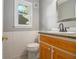 Small bathroom features a toilet and wood cabinet sink with granite countertops at 4819 Elam Rd, Stone Mountain, GA 30083