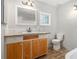 Bathroom boasts a wood vanity with stylish fixtures, great lighting, and a mirror at 4819 Elam Rd, Stone Mountain, GA 30083