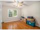 This cozy bedroom features wood floors, large windows, and a ceiling fan at 4819 Elam Rd, Stone Mountain, GA 30083