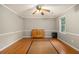 Bedroom features hardwood floors, natural light, and neutral wall paint at 4819 Elam Rd, Stone Mountain, GA 30083