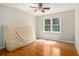 This bright bedroom has hardwood floors and natural light from large windows overlooking the backyard at 4819 Elam Rd, Stone Mountain, GA 30083