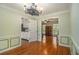 Charming dining room connects to kitchen & living area. Features include wainscoting, hardwood floors, and stylish lighting at 4819 Elam Rd, Stone Mountain, GA 30083