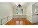 Charming dining room featuring classic wainscoting, hardwood floors, and an elegant chandelier at 4819 Elam Rd, Stone Mountain, GA 30083