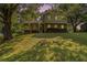 Charming two-story home featuring brick accents and a welcoming covered porch with beautiful landscaping and mature trees at 4819 Elam Rd, Stone Mountain, GA 30083