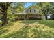 Two-story home featuring brick accents, a welcoming covered porch, beautiful landscaping, and mature trees at 4819 Elam Rd, Stone Mountain, GA 30083