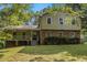 Charming home featuring brick accents, covered porch, a well-maintained lawn and inviting curb appeal at 4819 Elam Rd, Stone Mountain, GA 30083