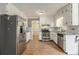 Bright kitchen features stainless steel appliances, granite counters, and tiled flooring at 4819 Elam Rd, Stone Mountain, GA 30083