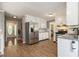 Bright, white kitchen featuring stainless steel appliances, granite countertops, and tile flooring at 4819 Elam Rd, Stone Mountain, GA 30083