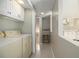 Laundry room features a washer, dryer, utility sink, and tile flooring at 4819 Elam Rd, Stone Mountain, GA 30083