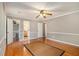Spacious main bedroom features a ceiling fan, hardwood floors, and access to the walk-in closet and ensuite bathroom at 4819 Elam Rd, Stone Mountain, GA 30083