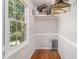 This walk-in closet offers ample storage space and a window for natural light, plus custom shelving and organizers at 4819 Elam Rd, Stone Mountain, GA 30083