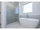 Modern bathroom showcasing a standalone tub with a sleek faucet and a glass-enclosed shower at 1011 Crown Oak St # 47, Johns Creek, GA 30022