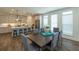 Open-concept kitchen and dining area features an island with bar stools and modern pendant lighting at 1011 Crown Oak St # 47, Johns Creek, GA 30022
