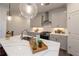 Updated kitchen featuring white cabinets, stainless steel hood, and quartz countertops at 1011 Crown Oak St # 47, Johns Creek, GA 30022