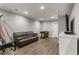Finished basement with hardwood floors, recessed lighting, a gray sofa, foosball table, TV, and a basketball game at 141 Ennisbrook Se Dr, Smyrna, GA 30082