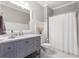 Clean bathroom with gray vanity, marble countertop, and a shower with a white curtain at 141 Ennisbrook Se Dr, Smyrna, GA 30082