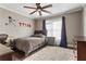 Comfortable bedroom with natural light, ceiling fan, a full-sized bed, desk and wood floors at 141 Ennisbrook Se Dr, Smyrna, GA 30082