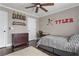 Comfortable bedroom with natural light, ceiling fan, a full-sized bed, desk and wood floors at 141 Ennisbrook Se Dr, Smyrna, GA 30082