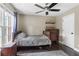 This is a simple bedroom with hardwood floors, window for natural light, and dark wooden furniture at 141 Ennisbrook Se Dr, Smyrna, GA 30082