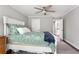 This is a well-lit bedroom featuring hardwood floors, a neutral color scheme, and a ceiling fan for added comfort at 141 Ennisbrook Se Dr, Smyrna, GA 30082