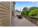 Spacious outdoor deck with an outdoor dining set, brown siding, and overlooking the backyard and nearby homes at 141 Ennisbrook Se Dr, Smyrna, GA 30082
