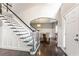 Bright foyer with hardwood floors, staircase, and an archway leading to the dining room at 141 Ennisbrook Se Dr, Smyrna, GA 30082