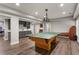 Finished basement featuring a ping pong table, a built-in bar, and wood-look floors at 141 Ennisbrook Se Dr, Smyrna, GA 30082