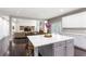 Open kitchen with white cabinets and island, flowing into the living room at 141 Ennisbrook Se Dr, Smyrna, GA 30082
