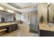 Bright main bathroom featuring double vanities, soaking tub, walk-in shower and neutral tile flooring at 141 Ennisbrook Se Dr, Smyrna, GA 30082