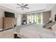 The main bedroom is spacious with hardwood floors, a ceiling fan, a large dresser, and lots of natural light at 141 Ennisbrook Se Dr, Smyrna, GA 30082