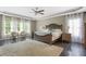 Spacious main bedroom features a ceiling fan, dark hardwood floors, lots of natural light, and sitting area at 141 Ennisbrook Se Dr, Smyrna, GA 30082