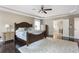 The main bedroom offers a ceiling fan, dark hardwood floors, lots of natural light, and a view of the bathroom at 141 Ennisbrook Se Dr, Smyrna, GA 30082