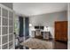 Home office with large windows, hardwood floors, desk, and comfortable chair at 141 Ennisbrook Se Dr, Smyrna, GA 30082