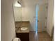 A bathroom featuring a vanity with a stylish countertop and a well-lit mirror at 3015 Liberty Nw Way, Atlanta, GA 30318